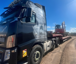 Building site moves lorry with bulldozer