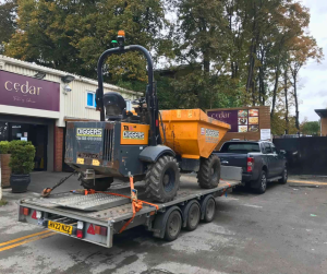 Building site moves lorry with construction digger